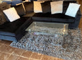 COMPLETE PACKAGE WITH BLACK SECTIONAL, COFFEE TABLE AND RUG