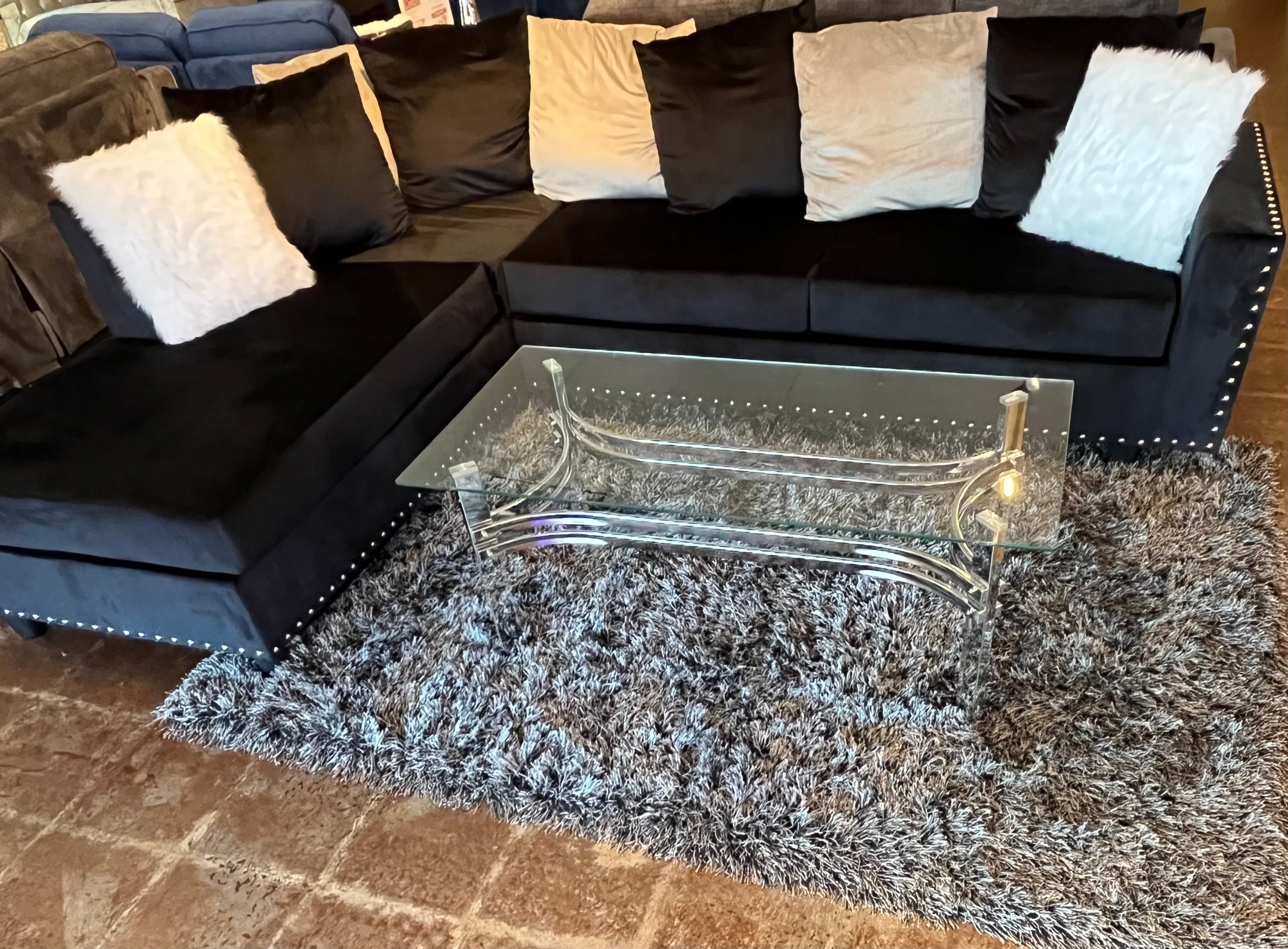 COMPLETE PACKAGE WITH BLACK SECTIONAL, COFFEE TABLE AND RUG